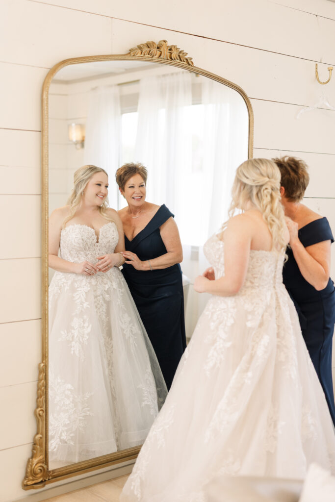 Bride and her mother at the gold arched mirror in the Lilly Creek Farm bridal suite